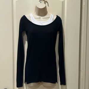 Split 59 off should black ribbed shirt w side slits and tank inset. Size XS.